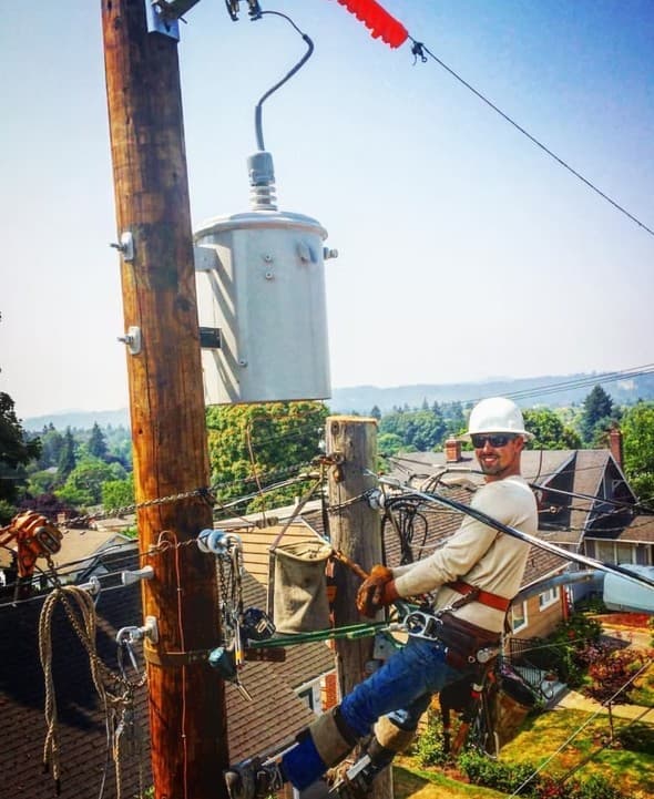 Lineman strapping in for climbing